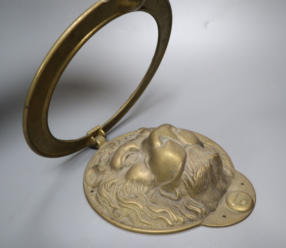 A large cast brass lions head door knocker, diameter 21cm